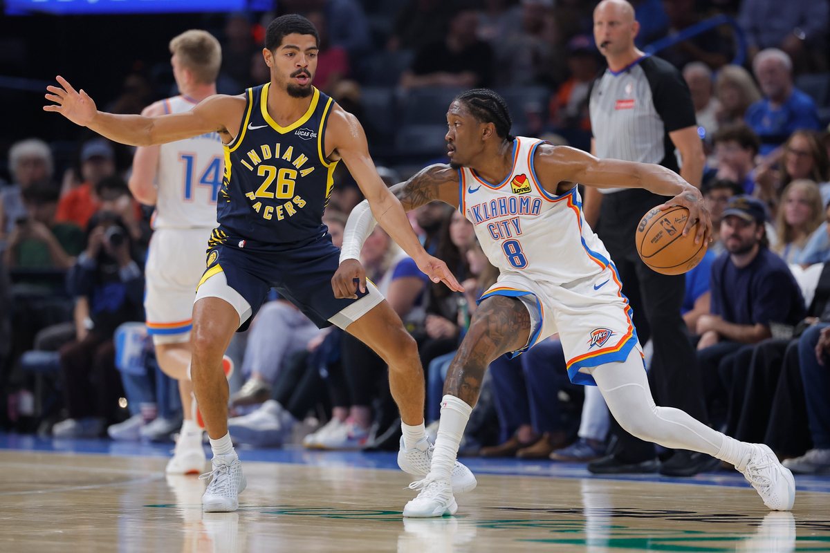 Ben Sheppard in a navy Pacers jersey defends Oklahoma City's Jalen Williams on the perimeter.