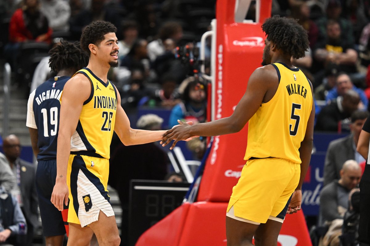 Ben Sheppard and Jarace Walker, both in gold Pacers jerseys, slap hands during a game in Washington.